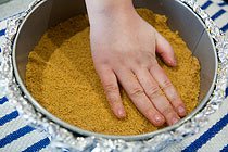 use your hands to press straight down graham cracker crumbs